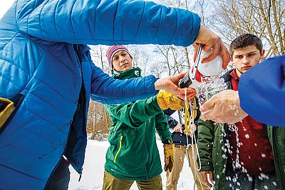 Landmark College students and professor conduct winter water ecology test 